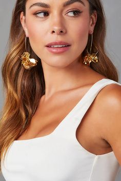 The ultra-lightweight Air Bloom Floral Drop Earrings in gold add the perfect amount of charm to casual and formal outfits alike. Length: 3” Weight: 0.4 oz Gold Plated Brass Material Flower Drop Pendant Elegant Summer Dangle Hoop Earrings, Gold Dangle Earrings For Summer, Chic Gold Earrings For Summer, Party Gold-tone Drop Hoop Earrings, Chic Gold Jewelry For Summer, Metal Hoop Earrings For Summer Parties, Gold Drop Earrings For Spring, Elegant Dangle Hoop Earrings For Spring, Gold-tone Dangle Hoop Earrings For Party