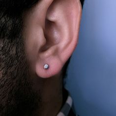 a man wearing a pair of ear piercings