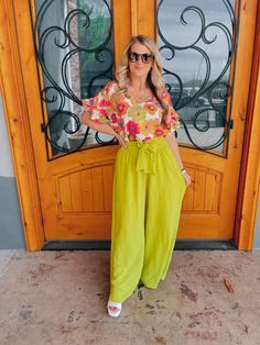 Elevate your style with our "She Stands Out" pants. These high-waisted palazzo pants offer both comfort and airflow, perfect for any occasion. The self-tie in the front and smocked back add a touch of elegance to these vibrant lime-colored pants. Feel confident and stand out in the crowd with our statement piece. Paired with our 'Petal Picking' Top and our 'Work of Art' Top Inseam: 30" Model is 5'1 and has on 3" block heels Flowy Spring Vacation Bottoms, Trendy Wide Leg Pants For Vacation, Summer Straight Rayon Pants, Green Wide Leg Pants For Day Out, Chic Green Wide Leg Pants For Summer, Trendy Rayon Bottoms For Spring, Summer Rayon Trousers, Summer Wide-leg Rayon Pants, Bohemian Flowy Bottoms For Brunch