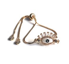 "Evil Eye Gold Bracelet This is a bolo chain modern bracelet gold plated completely adjustable with a gorgeous abalone stone and micro pave 1' / 2.5 cm oval shape evil eye 18K gold plated connector. It has a comfortable bead that you slide into position up and down the chain to allow the perfect fit. This bracelet is trendy, delicate, and easy to take on and off, simply slide the oval bead up to fit your wrist and pull it down to remove your bracelet. When wearing the bracelet the delicate chain Party Gold Plated Chain Bracelet, Adjustable Rose Gold Charm Bracelet For Parties, Gold Evil Eye Bracelet With Adjustable Length As Gift, Adjustable Gold Plated Chain Bracelet For Party, Adjustable Gold Charm Bracelet For Party, Gold Adjustable Chain Bracelet For Party, Adjustable Gold Plated Charm Bracelet, Trendy Gold Jewelry With Adjustable Clasp, Resizable Gold Plated Bracelets