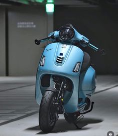 a blue scooter parked in a parking garage