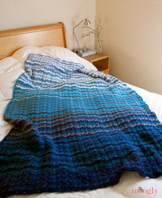 a bed with a blue blanket on top of it