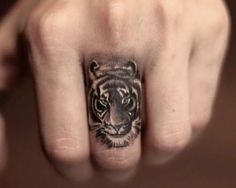 a hand with a tiger tattoo on it