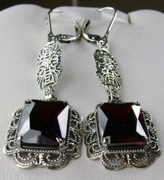 Red Garnet Cubic Zirconia (CZ) Earrings Festoon Design#E8 (long version) Custom Made These are Victorian reproduction estate earrings in sterling silver set with stunning red garnet cubic zirconia gemstones. Each festoon earring is 23mm x 13mm in dimension. The earrings are 2 inches long. The earrings closures are choice of ear wires, deco posts, or lever-backs. Most popular for this earring are the posts and the lever-back style for comfortable wear, and to prevent loss. These lovely earrings w Elegant Red Crystal Earrings, Ornate Red Dangle Earrings, Formal Dangle Garnet Earrings, Formal Garnet Dangle Earrings, Ornate Red Earrings For Party, Elegant Garnet Drop Earrings, Red Filigree Dangle Earrings, Formal Ruby Earrings With Intricate Design, Red Ruby Earrings With Intricate Design