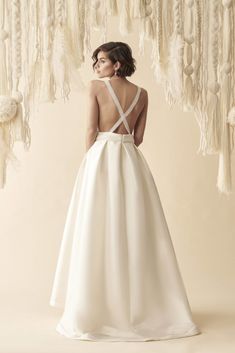 a woman in a white wedding dress looking back