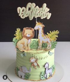 a green cake decorated with animals and letters