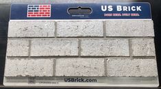 a close up of a brick wall with the words us brick on it's side