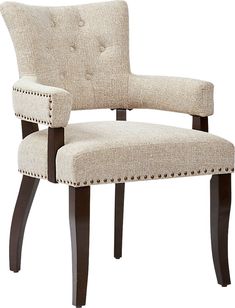 an upholstered chair with nail - tipped legs and a buttoned backrest