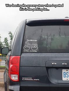 the back end of a black van with stickers on it's side window