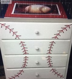 a baseball themed dresser with red stitches on it