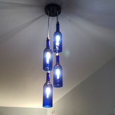 several blue bottles are hanging from the ceiling