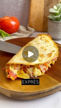 a wooden plate topped with a quesadilla on top of a cutting board