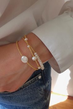 Adorn your wrist with the exquisite charm of our Dainty Pearl Triple Bracelet. This triple bracelet, delicately crafted on three chains, combines the timeless allure of pearls with the sophistication of gold-plated elegance. Elevate your style with the understated beauty of this triple-strand bracelet—a symbol of triple elegance. 🌼💫 #PearlTripleBracelet #GoldPlatedElegance #DaintyBrassBracelet #TimelessCharm Elegant Gold-plated Bracelets For Layering, Elegant Bracelet With Adjustable Chain For Layering, Elegant Bracelets With Adjustable Chain For Layering, Elegant Adjustable Chain Bracelet For Layering, Elegant Jubilee Chain Bracelet For Layering, Elegant Handmade Gold-plated Beaded Bracelets, Elegant Handmade Gold-plated Beaded Bracelet, Elegant Handmade Adjustable Gold Bracelet, Elegant Handmade Adjustable Chain Bracelet