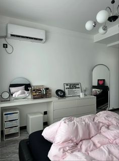 a bedroom with a bed, dresser and air conditioner on the wall next to it