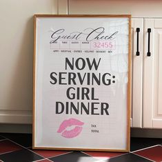 a poster with the words now serving girl dinner on it in front of a kitchen counter