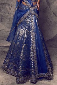 Blue brocade lehenga with an attached cancan, woven pattern and mirror, kasab and gold thread embroidery. Comes with a padded corset and an organza drape.
Components: 3
Pattern: Woven, Embroidered
Type Of Work: Mirror, Kasab, Thread
Neckline: Sweetheart
Sleeve Type: Sleeveless
Fabric: Brocade, Drape: Organza
Color: Blue
Other Details: 
Length: Lehenga - 43 inches
Closure: Corset - Back tie-up
Occasion: Destination Wedding,Bride - Aza Fashions Royal Blue Lehenga With Intricate Embroidery, Royal Blue Lehenga With Cutdana In Traditional Drape, Blue Organza Anarkali Set With Pallu, Traditional Royal Blue Lehenga For Reception, Royal Blue Choli For Wedding And Navratri, Blue Organza Sharara With Pallu, Royal Blue Sharara With Pallu For Reception, Royal Blue Lehenga With Intricate Embroidery For Festivals, Blue Chanderi Lehenga For Wedding