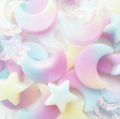 several stars and crescents are laying on top of some plastic doughnuts with pastel colors