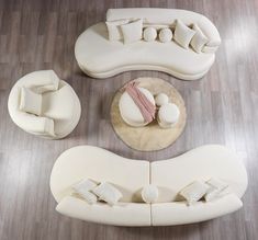 an overhead view of a living room with white furniture