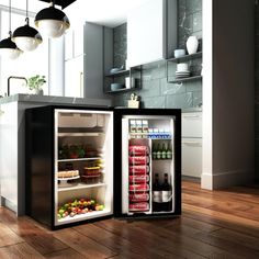 two open refrigerators sitting on top of a wooden floor