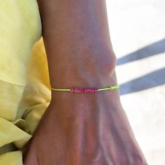 "Mens Neon Yellow String With Fuchsia Beads Bracelet Beaded Bracelet Yoga Natural Earthy Jewelry Adjustable Neon Thread Surf Vegan Unisex Surfer Bracelet Minimalist Traveler Gift - perfect as a gift for a best friend or for that beach/surfer look - adjustable bracelet - waterproof - neon yellow string - 11 high quality 1.5mm japonese fuchsia cube beads *Listing is for one bracelet. Particle's signature bracelets make perfect gift ideas. Each bracelet is mounted on a Particle card and packaged ready for gift giving. If you have any questions about this string bracelet, just hit the \"Ask a Question\" button next to the price and we will get back to you within 24 hours. SHIPPING Please view our shipping information under Policy (below) ✻ Follow us on INSTAGRAM: @particlebracelets ✻ Follow us Surfer Look, Surf Bracelet, Signature Bracelet, Earthy Jewelry, Surfer Bracelets, Bracelet Minimalist, Cube Beads, Minimalist Bracelet, Bracelet Beaded