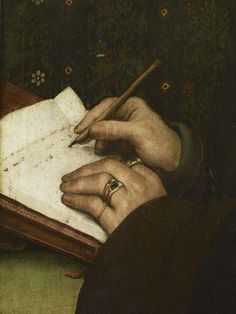 a close up of a person writing on a piece of paper with a pen in their hand