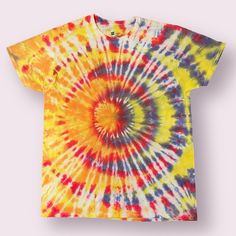 a colorful tie - dyed t - shirt is shown on a white background with the colors yellow, red, and blue