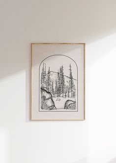 a black and white drawing hanging on the wall