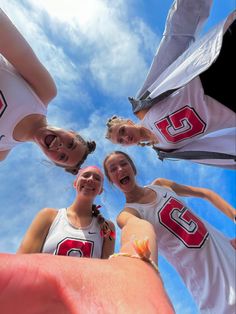 three girls are standing in a circle with their arms around each other and one girl is holding out her hand to the camera