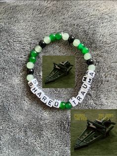 a green and white beaded bracelet with a fighter jet in the middle on a gray background