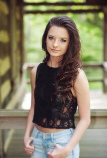 a young woman is posing for the camera