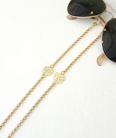 Sunglasses gold chain,  Eyeglass necklace, Flowers sunglasses chain, Dainty reading glasses gold chain, Trendy Chain, Eyewear Holder Chain Beautiful fashion trend sunglasses gold plated aluminum chain decorated with gold plated flowers Lightweight gold chain with rubber ends Total length is 70cm / 27.7 inches. Beautifully packaged and ready for gift giving.  JEWELRY CARE: Please take care of your jewelry do not wear in the shower, swimming pool, or to bed.  Keep away from harsh chemicals and cle Trendy Gold Glasses Chain For Gift, Trendy Gold Glasses Chains As Gift, Gold Chain Necklace As Summer Gift, Trendy Gold Chain Glasses Chains As Gift, Gold Chain Necklace Summer Gift, Trendy Gold Chain Glasses Chain For Gift, Elegant Metal Glasses Chains For Summer, Summer Gold Glass Necklaces, Gold Necklace With Chain Strap For Summer