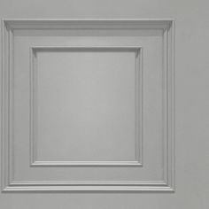 an image of a white square frame on the wall with no background or text in it