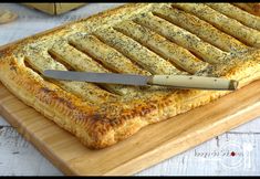 there is a large pastry on the cutting board with a knife