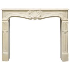 a white fireplace with an ornate design on the top and bottom part, against a white background