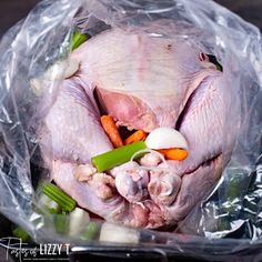 an uncooked chicken is wrapped in plastic