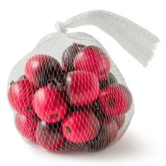 a mesh bag filled with lots of red apples