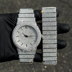 Step into elegance with this fully iced-out diamond watch and bracelet set that mirrors genuine luxury watches. We utilize premium simulated diamonds crafted from high-refractive crystals, ensuring a sparkle that rivals authentic diamonds under the light! INCLUDES AN EASY-TO-USE SIZE ADJUSTMENT TOOL Specifications: - Gender: Men's - Case Size: 46mm - Sizing: 8.5-inch band - Bracelet Length: 9-inches (Non-adjustable) - Movement: Quartz Movement - Battery: Included - Adjustable: Watch Links are re Iced Out Jewelry Men, White Gold Diamond Watch With Rhinestones, Cubic Zirconia Diamond Watch With Bling, Silver Stainless Steel Diamond Watch With Diamond Accents, Silver Bling Jewelry And Watches With Cubic Zirconia, Diamond Watches, Silver Diamond Watch With Bling, White Gold Cubic Zirconia Bling Watch, Luxury Diamond Watch With Bling And Stainless Steel