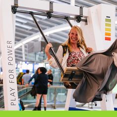 a woman sitting on a swing in an indoor area