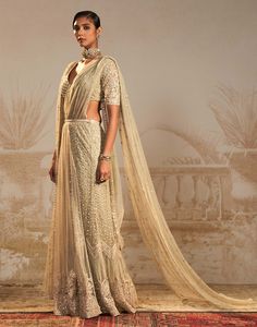 Step into sophistication with this silver green persian embroidered sari set – a perfect harmony of tradition and contemporary flair. This stunning ensemble features a pre-draped sari and drape blouse, intricately embroidered in silver green motifs. The striking color and persian-inspired design add a regal touch, making it an ideal choice for special occasions. Traditional Embellished Pre-draped Saree In Raw Silk, Pista Green Blouse With Sheer Dupatta For Reception, Embellished Anarkali Tissue Silk Pre-draped Saree, Anarkali Style Embellished Tissue Silk Pre-draped Saree, Floor-length Pre-draped Saree With Dupatta, Pista Green Pre-draped Saree For Diwali Reception, Pista Green Anarkali Floor-length Pre-draped Saree, Pre-draped Tissue Silk Saree With Sheer Dupatta For Reception, Cutdana Pre-draped Saree For Reception And Diwali