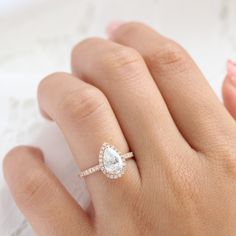 Pear Shaped Engagement Rings With Halo, Pear Shape Halo Engagement Ring, Pear Halo Engagement Ring Rose Gold, Timeless Pear-shaped Halo Diamond Ring, Elegant Rose Gold Pear-shaped Rings, Elegant Rose Gold Pear-shaped Diamond Ring, Fine Jewelry Pear-shaped Halo Ring For Wedding, Pear Halo Ring, Pear Engagement Ring Halo