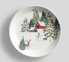 a white plate decorated with christmas trees and snowmen