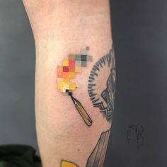 a person with a tattoo on their leg has a cross and a clock in it