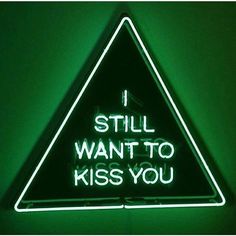 a neon sign that says i still want to kiss you on the inside of it