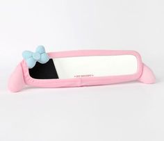 a pink mirror with a blue bow on the front and back of it, against a white background