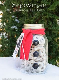 a mason jar filled with buttons and snowman decorations