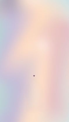 a blurry image of a small bird flying in the sky with a pink and blue background