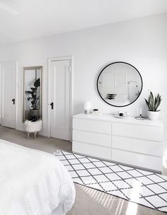 a white bedroom with black and white decor