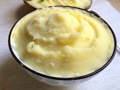 a bowl filled with mashed potatoes on top of a table