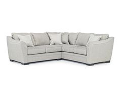 a large sectional couch with pillows on the top and bottom corner, in light gray fabric