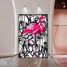 a pink flamingo standing in front of a black and white wall